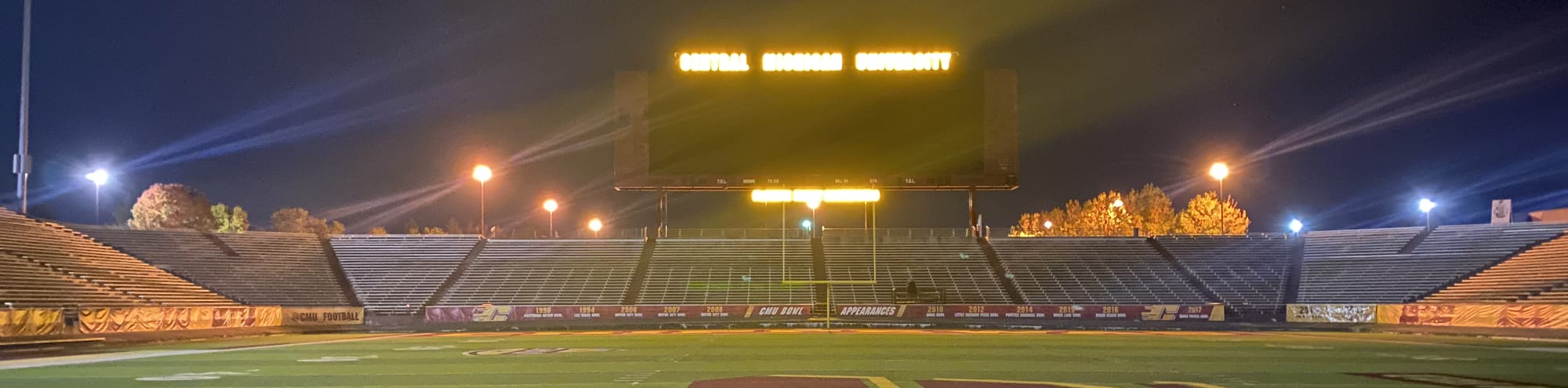 empty football stadium at night under the lights Denver